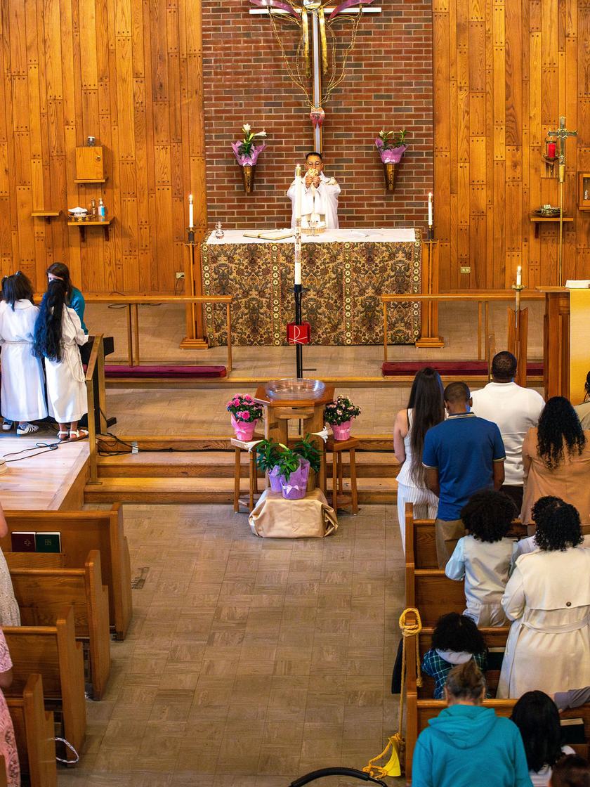 Sunday worship at Trinity: the congregation gathered in the pews as Holy Communion is administered at the altar